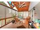 Relaxing screened porch featuring comfortable seating and a ceiling fan for warm weather enjoyment at 4646 River Run Cir, Hickory, NC 28602