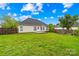 Large backyard with green grass, a wooden fence, and the rear of the home at 4809 Mossy Cup Ln, Monroe, NC 28110
