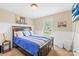 Well-lit bedroom with wall trim, carpeted floors, and a picturesque window view at 4809 Mossy Cup Ln, Monroe, NC 28110