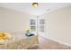 Cozy bedroom with neutral walls, carpeted floors, and a sunny double window at 4809 Mossy Cup Ln, Monroe, NC 28110