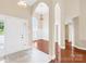 Welcoming foyer showcasing hardwood floors, arched entryways, and natural light at 4809 Mossy Cup Ln, Monroe, NC 28110