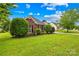 Quaint home with a lush green lawn and meticulous landscaping at 4809 Mossy Cup Ln, Monroe, NC 28110