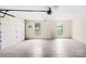 Spacious two car garage with windows, overhead door opener, and concrete flooring at 4809 Mossy Cup Ln, Monroe, NC 28110
