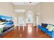 Spacious living room featuring hardwood floors, a vaulted ceiling, and lots of natural light at 4809 Mossy Cup Ln, Monroe, NC 28110