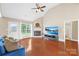 Comfortable living room with natural light, beautiful hardwood floors, and cozy fireplace at 4809 Mossy Cup Ln, Monroe, NC 28110