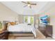 Spacious bedroom with a tray ceiling, ceiling fan, neutral carpet and natural light at 4809 Mossy Cup Ln, Monroe, NC 28110