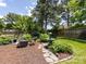 Tranquil backyard with cozy firepit seating area, landscaping, and a water fountain creating a peaceful retreat at 4925 Cedar Forest Dr, Charlotte, NC 28226