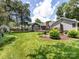 Lush backyard featuring a well-manicured lawn, mature trees, landscaping, and a charming water fountain feature at 4925 Cedar Forest Dr, Charlotte, NC 28226