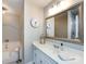 Bright bathroom features a tub, white vanity with a framed mirror and updated fixtures at 4925 Cedar Forest Dr, Charlotte, NC 28226