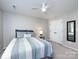 Bedroom with a ceiling fan, carpet, neutral walls, and a bed with blue bedding at 4925 Cedar Forest Dr, Charlotte, NC 28226
