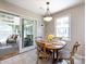 A casual dining area featuring a round wood table, seating for four, and sliding glass doors at 4925 Cedar Forest Dr, Charlotte, NC 28226