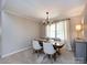 Cozy dining room with a classic table, chandelier, and soft natural light, creating an elegant atmosphere at 4925 Cedar Forest Dr, Charlotte, NC 28226