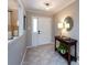 Stylish entryway featuring tiled flooring, a console table with a lamp, and a view into the dining area at 4925 Cedar Forest Dr, Charlotte, NC 28226