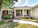 Inviting front porch with brick steps, cozy seating, and charming details like an American flag at 4925 Cedar Forest Dr, Charlotte, NC 28226