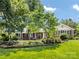 Well-maintained brick home with lush lawn and mature trees, offering great curb appeal and a welcoming atmosphere at 4925 Cedar Forest Dr, Charlotte, NC 28226