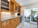 A kitchen featuring maple cabinetry, stainless steel appliances, and an adjacent sunroom at 4925 Cedar Forest Dr, Charlotte, NC 28226
