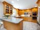 Charming kitchen features wooden cabinetry, stainless steel appliances, granite countertops, and tiled floors at 4925 Cedar Forest Dr, Charlotte, NC 28226