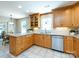 Well-lit kitchen with wooden cabinets, stainless steel appliances, and a cozy breakfast nook for casual dining at 4925 Cedar Forest Dr, Charlotte, NC 28226
