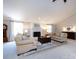 Inviting living room boasts a white fireplace, two sofas, and a wooden coffee table on a patterned rug at 4925 Cedar Forest Dr, Charlotte, NC 28226