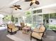 Light-filled sunroom with three ceiling fans and comfortable seating overlooking the green backyard at 4925 Cedar Forest Dr, Charlotte, NC 28226
