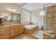 Elegant bathroom featuring a soaking tub and a glass-enclosed shower at 499 Granite Lake Ct, Denver, NC 28037