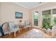 Bright breakfast nook featuring a glass table, hardwood floors, and a door to the outside at 499 Granite Lake Ct, Denver, NC 28037