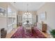 Bright dining room with a chandelier, hardwood floors, and large windows at 499 Granite Lake Ct, Denver, NC 28037