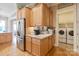 Kitchen featuring stainless steel appliances, granite countertops, and adjacent laundry area at 499 Granite Lake Ct, Denver, NC 28037