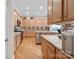 Well-lit kitchen with mosaic backsplash, wooden cabinetry, and granite countertops at 499 Granite Lake Ct, Denver, NC 28037