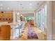 Well-lit kitchen with a long island, hardwood floors, and access to the outdoor patio at 499 Granite Lake Ct, Denver, NC 28037