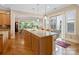 Modern kitchen featuring a large island with seating, pendant lights, and open access to the living area at 499 Granite Lake Ct, Denver, NC 28037