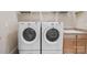 Convenient laundry area with side by side machines, shelving, and utility sink at 499 Granite Lake Ct, Denver, NC 28037