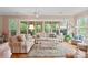 Cozy living room with comfortable striped couches, large windows, and natural light at 499 Granite Lake Ct, Denver, NC 28037