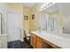 Well-lit bathroom with a large mirror, wooden vanity, toilet, and a combination tub and shower at 513 Pate Dr, Fort Mill, SC 29715