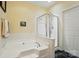 Bright bathroom showcasing a soaking tub, shower stall, and a white-tiled wall at 513 Pate Dr, Fort Mill, SC 29715