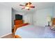 This bedroom features a ceiling fan, wood dresser and flooring, and lots of light at 513 Pate Dr, Fort Mill, SC 29715