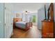 Bright bedroom featuring hardwood floors, wooden furnishings, and natural light streaming through the windows at 513 Pate Dr, Fort Mill, SC 29715