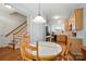 Open dining area next to staircase and kitchen with wooden floors and round dining table at 513 Pate Dr, Fort Mill, SC 29715