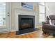 Elegant fireplace with white mantel, black slate surround and hearth, and glass-enclosed firebox at 513 Pate Dr, Fort Mill, SC 29715
