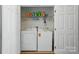 This laundry room features hardwood floors, a washer and dryer, and lots of storage at 513 Pate Dr, Fort Mill, SC 29715