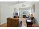 Cozy living room with a fireplace, ceiling fan, and large windows for natural light at 513 Pate Dr, Fort Mill, SC 29715