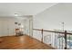 Open loft area with wood floors, a sewing machine, and access to the downstairs living room at 513 Pate Dr, Fort Mill, SC 29715