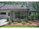 Exterior view of a house with a screened porch, outdoor seating and landscaped backyard at 516 Amanda Dr, Weddington, NC 28104