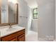 Bathroom with a vanity, decorative mirror, and a tiled shower at 516 Amanda Dr, Weddington, NC 28104