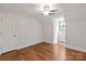 Bright bedroom featuring hardwood floors, a ceiling fan, and a large window at 516 Amanda Dr, Weddington, NC 28104