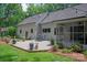 Exterior view of a house with a brick patio, a screened porch, and a landscaped backyard at 516 Amanda Dr, Weddington, NC 28104