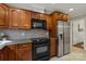 A well-equipped kitchen features wooden cabinets, granite countertops, and stainless steel appliances at 516 Amanda Dr, Weddington, NC 28104