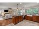 Open kitchen featuring a large island with granite countertops, tile backsplash, and stainless steel appliances at 516 Amanda Dr, Weddington, NC 28104