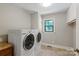 Well-lit laundry room with a side-by-side washer and dryer set and a window at 516 Amanda Dr, Weddington, NC 28104