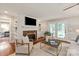 Cozy living room with a brick fireplace, built-in shelving, and French doors at 516 Amanda Dr, Weddington, NC 28104